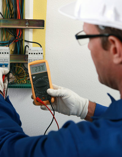 An electrician checking the energy meter.